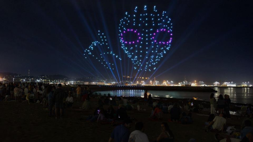 Drone show creating a luminous and colorful figure in the night sky, standing out in the darkness.